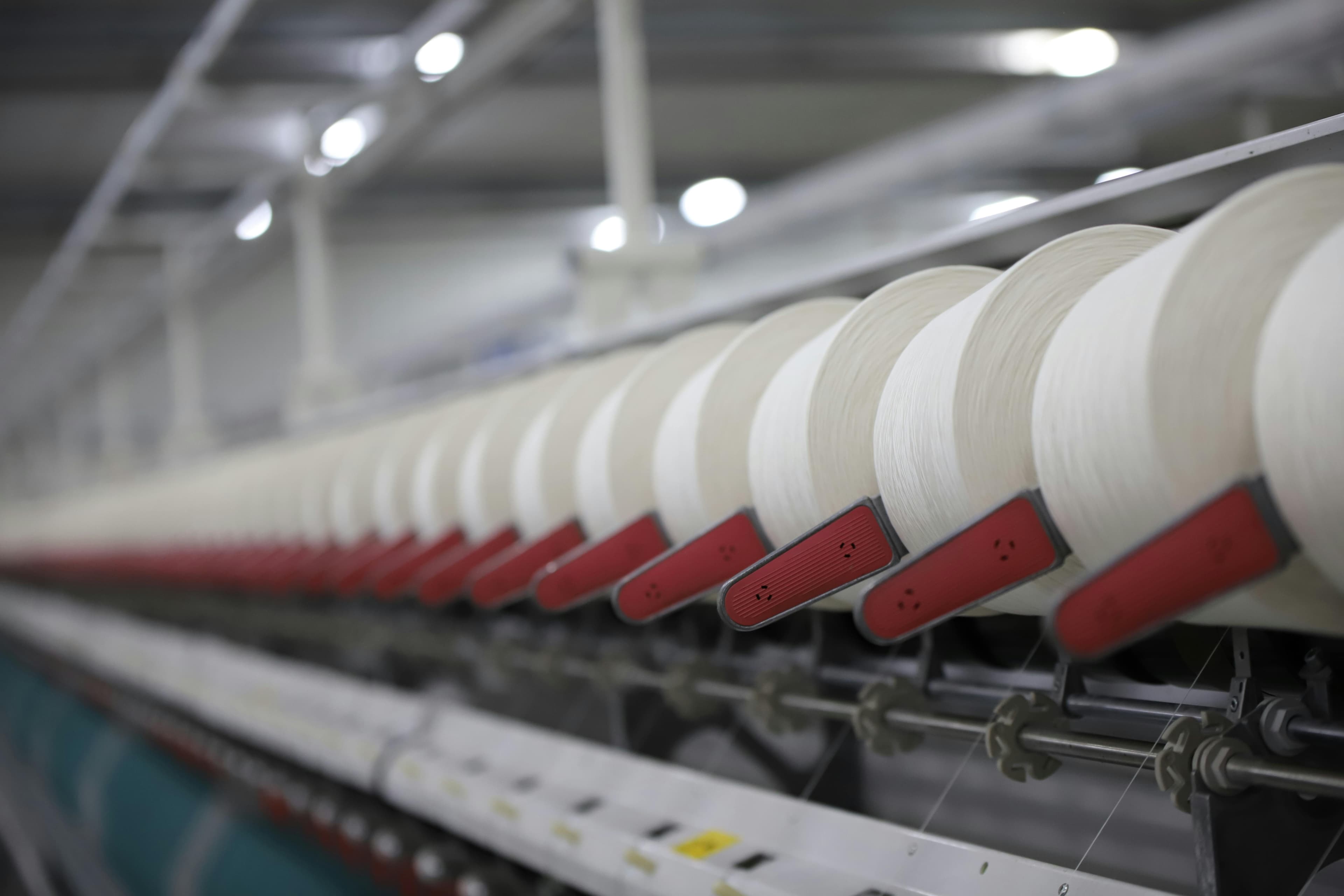 Argon Denims spinning floor · long-lens cone row.